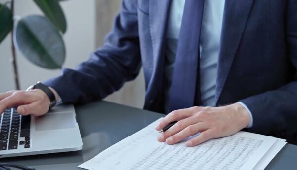 Accountant reviewing financial statements to reduce errors and prevent liability risks.