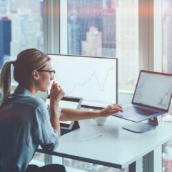 Accountant reviewing AI-generated financial analytics on computer screen