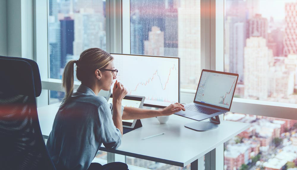 Accountant reviewing AI-generated financial analytics on computer screen