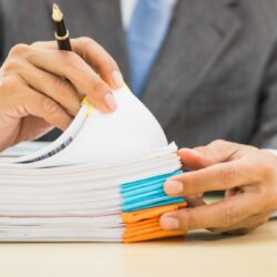 Attorney reviewing case files and deadlines to help reduce legal malpractice risk and professional liability exposure
