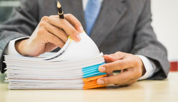 Attorney reviewing case files and deadlines to help reduce legal malpractice risk and professional liability exposure