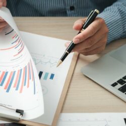 CPA reviewing financial reports to assess professional liability coverage