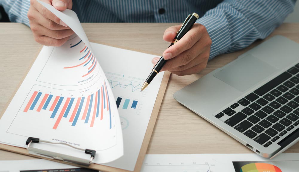 CPA reviewing financial reports to assess professional liability coverage