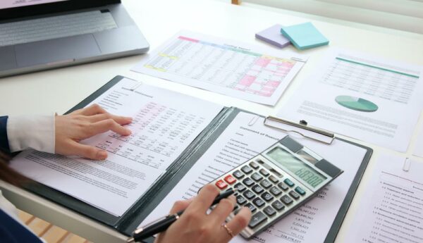Accountant reviewing financial statements to reduce errors and prevent liability risks.
