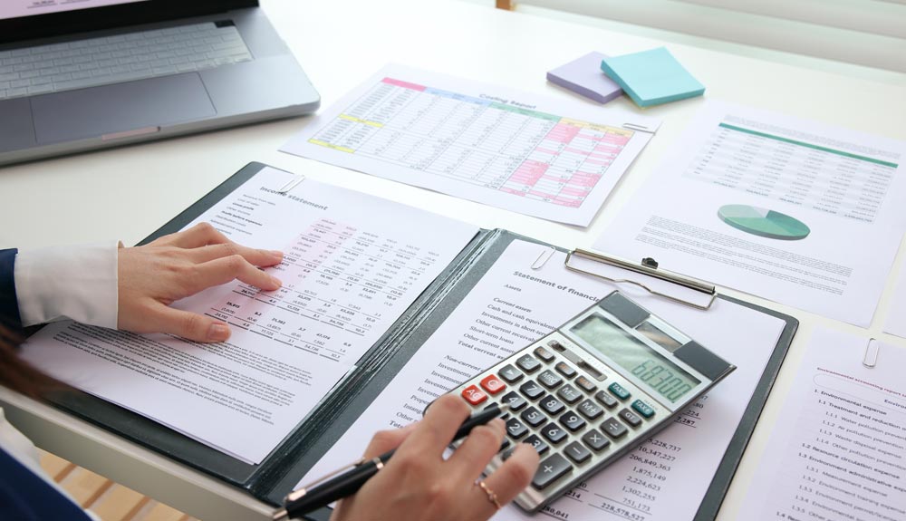 Accountant reviewing financial statements to reduce errors and prevent liability risks.