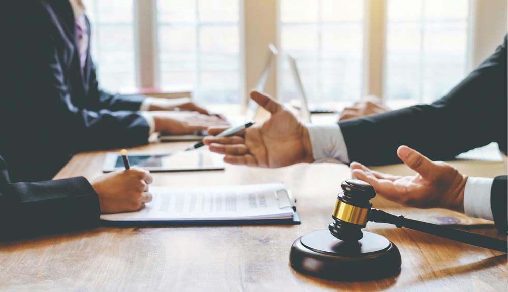 Attorney reviewing legal documents as part of a law firm's professional liability and risk management strategy