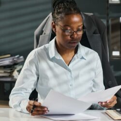 Small law firm attorneys reviewing client intake documents to prevent conflicts of interest